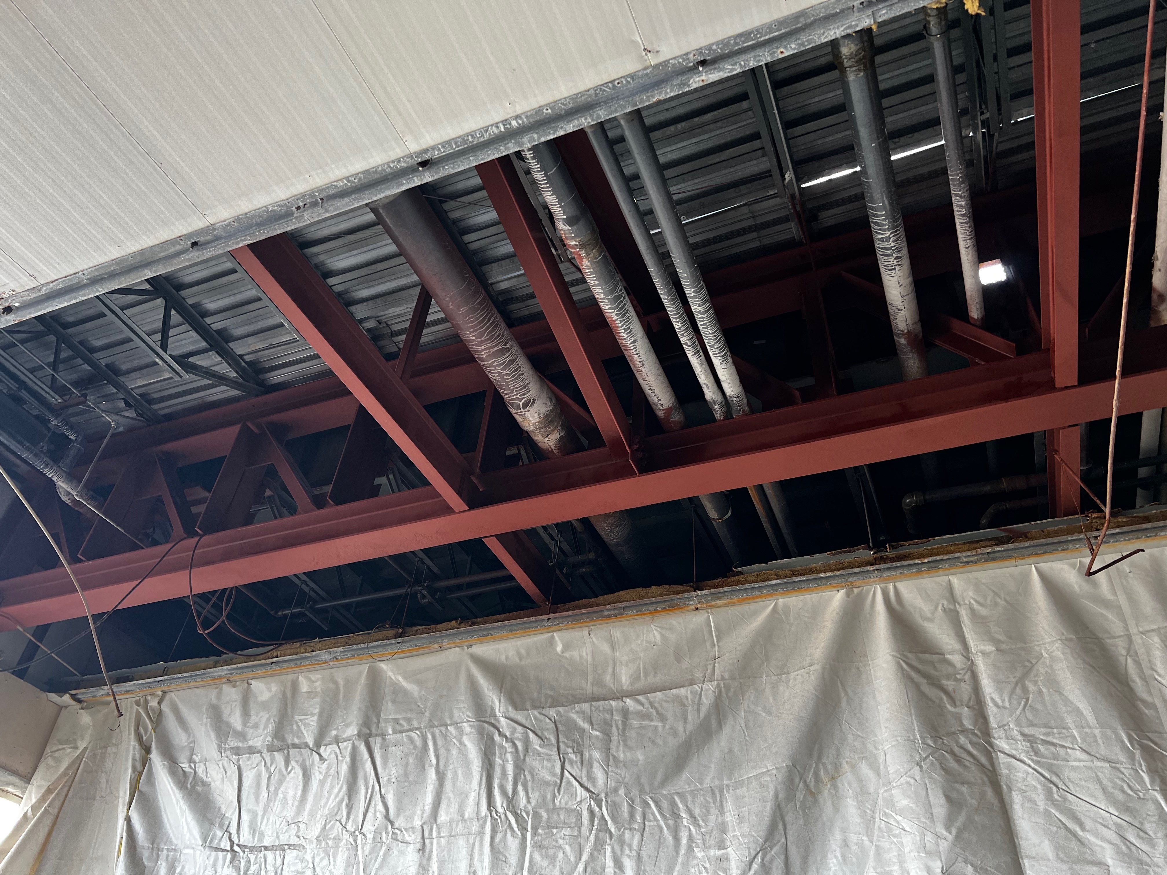  Painting of steel support beams below Sheraton Hotel waterpark in parking garage ceiling