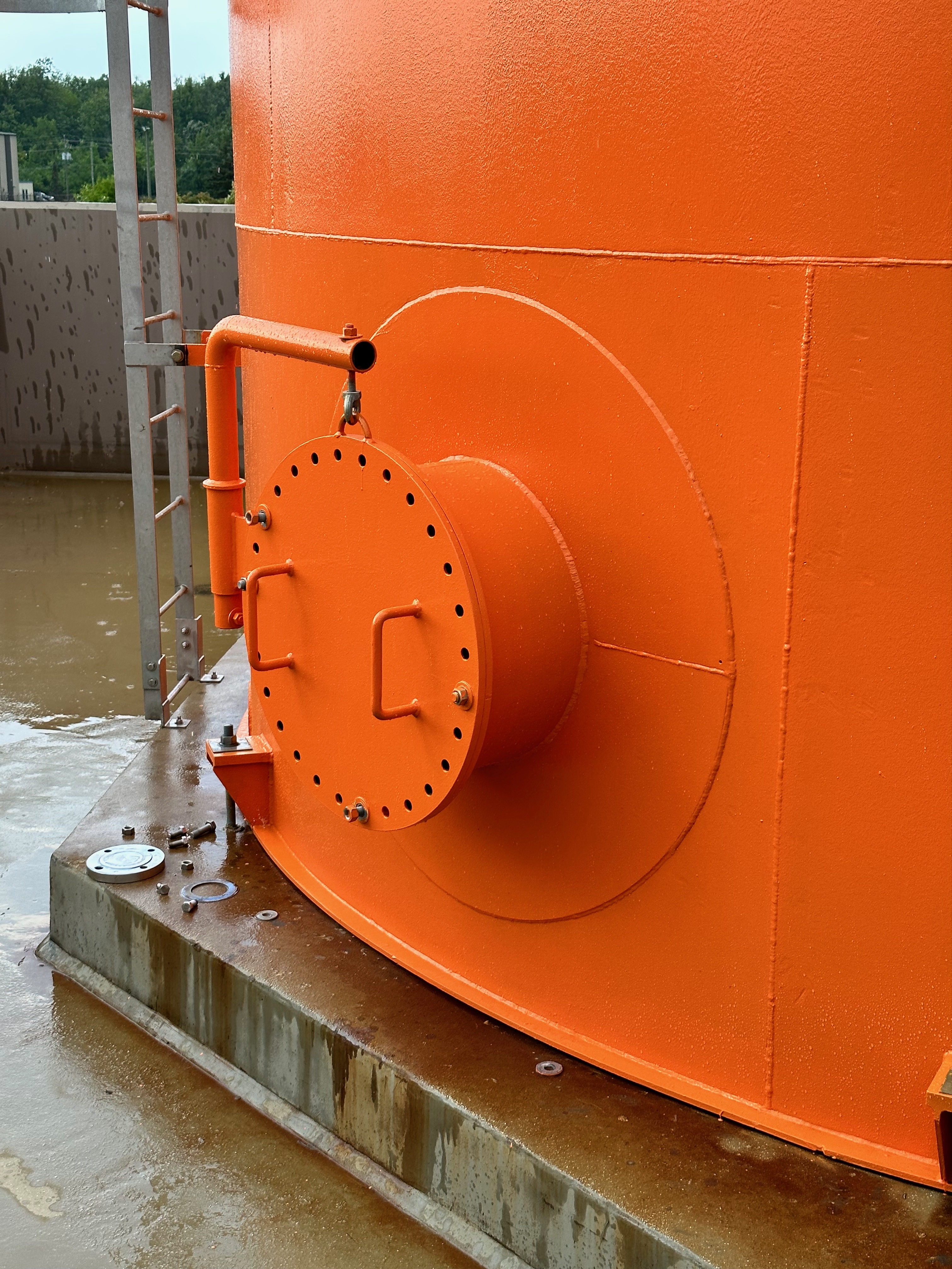  Coated industrial storage tank in bright orange